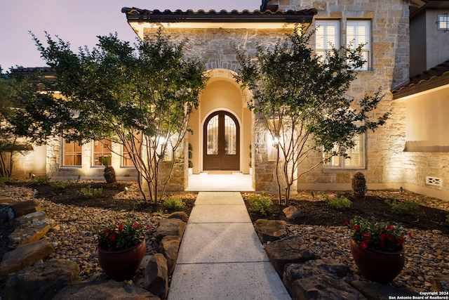 view of exterior entry at dusk