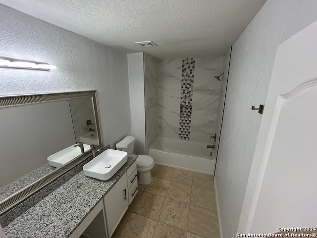 full bathroom featuring tile floors, shower / bath combination, toilet, and vanity