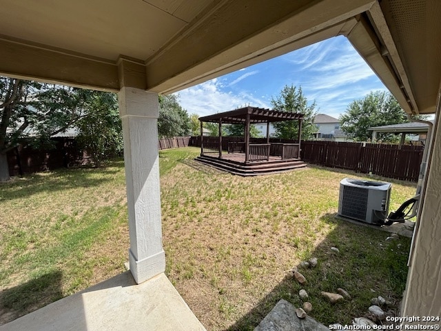 view of yard featuring a pergola and central AC