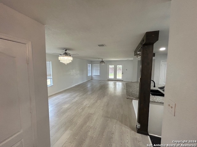 hallway featuring sink and light hardwood / wood-style floors