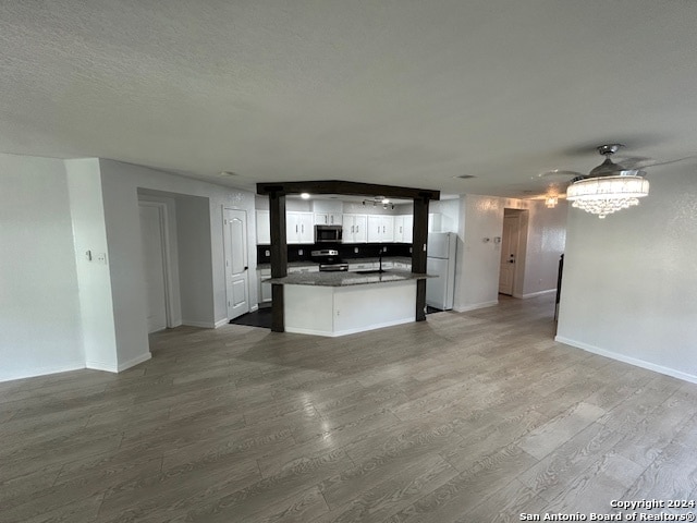 unfurnished living room featuring sink and hardwood / wood-style flooring