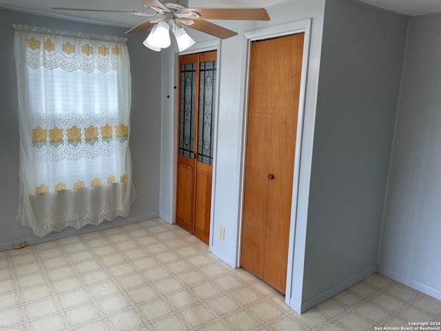 unfurnished bedroom with ceiling fan and light tile flooring