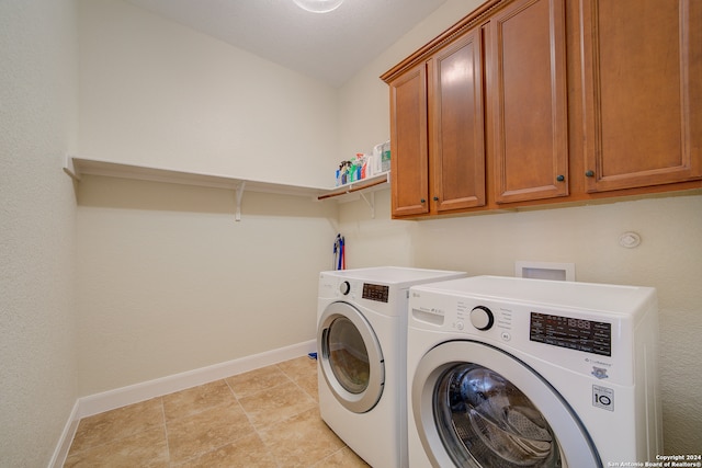 washroom featuring cabinets, washing machine and dryer, light tile flooring, and hookup for a washing machine