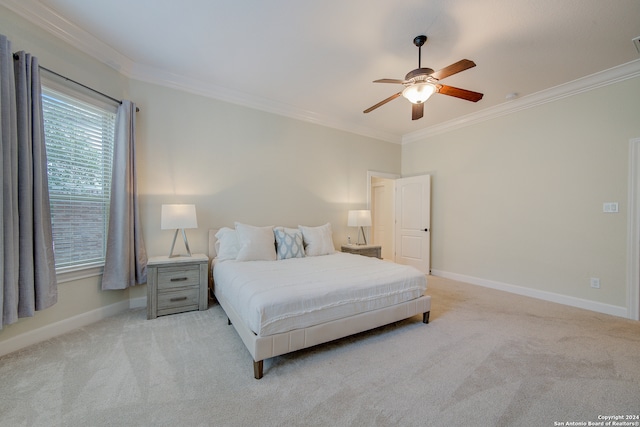 bedroom with crown molding, ceiling fan, and light colored carpet