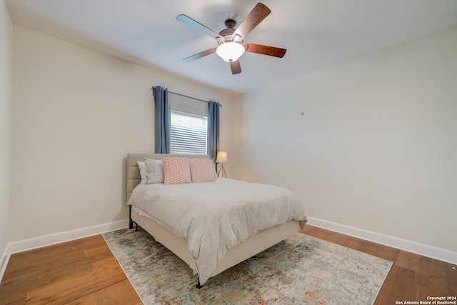 bedroom with wood-type flooring and ceiling fan