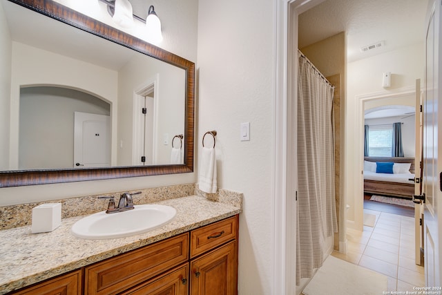 bathroom featuring vanity and tile floors