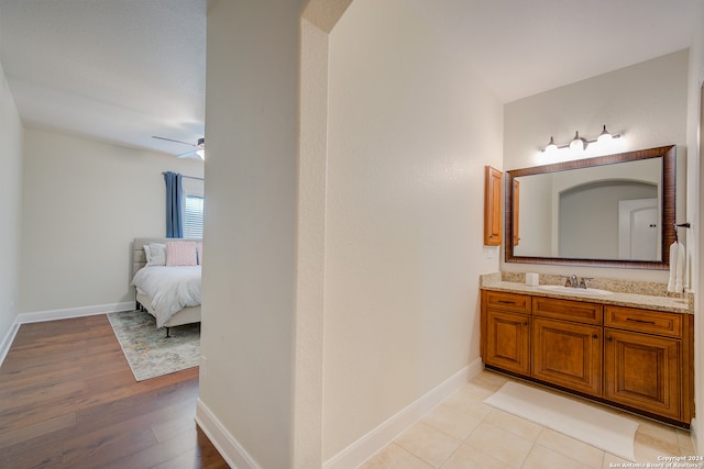 bathroom featuring tile floors, ceiling fan, and vanity