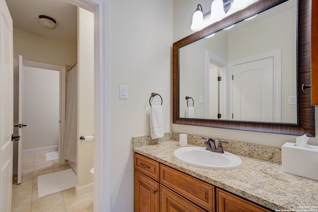 bathroom with vanity, toilet, and tile floors