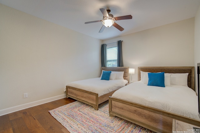 bedroom with dark wood-type flooring and ceiling fan