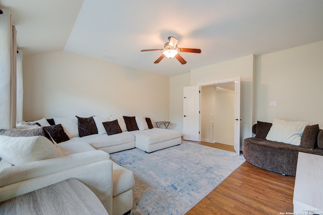 living room with hardwood / wood-style floors, ceiling fan, and lofted ceiling