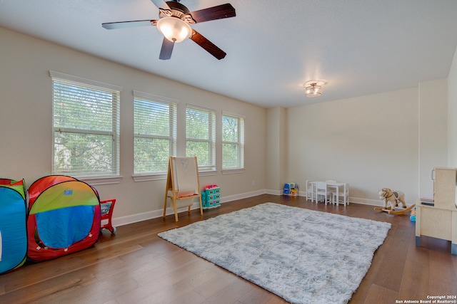 recreation room with ceiling fan and hardwood / wood-style floors