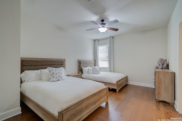 bedroom featuring ceiling fan and hardwood / wood-style floors