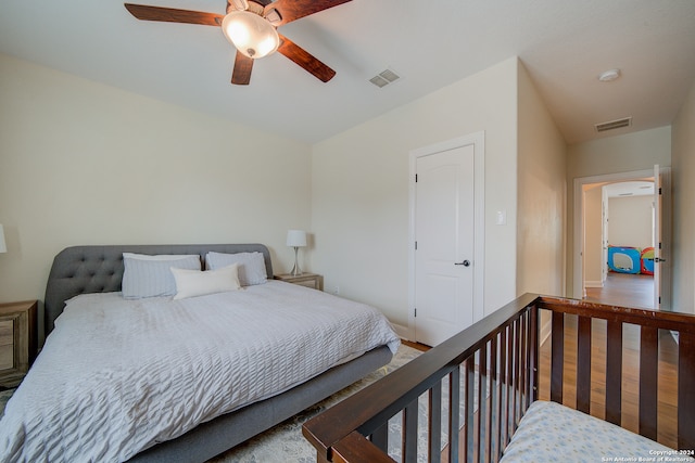 bedroom with ceiling fan and hardwood / wood-style flooring