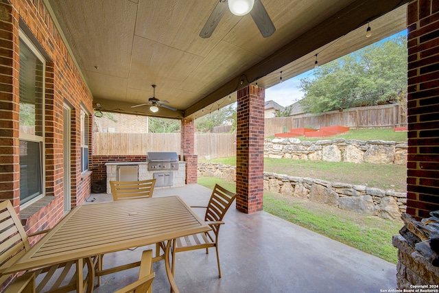 view of patio featuring ceiling fan, an outdoor kitchen, and grilling area