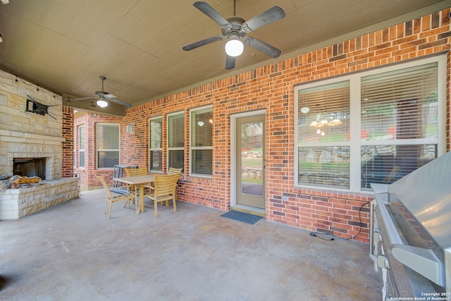 view of patio featuring ceiling fan and an outdoor stone fireplace