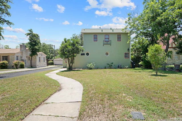 view of property exterior with a garage and a lawn