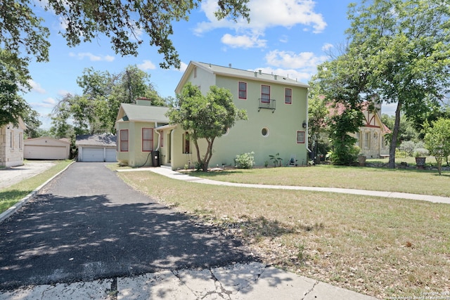 view of front of home with a garage and a front lawn