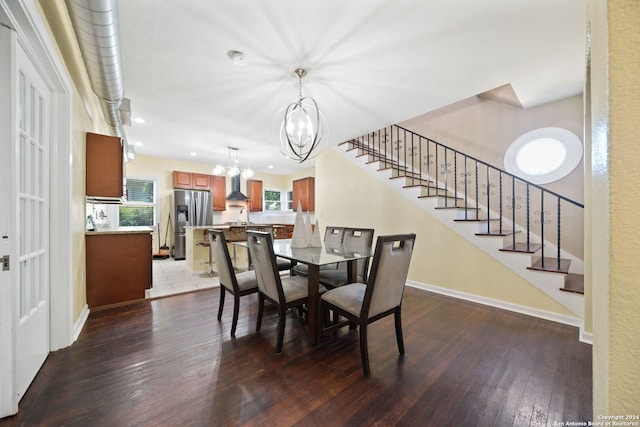 dining room featuring sink, hardwood / wood-style floors, and a chandelier