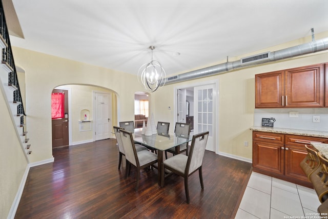 dining area featuring a notable chandelier and wood-type flooring