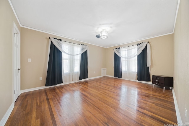 unfurnished room featuring a healthy amount of sunlight, hardwood / wood-style flooring, and ornamental molding