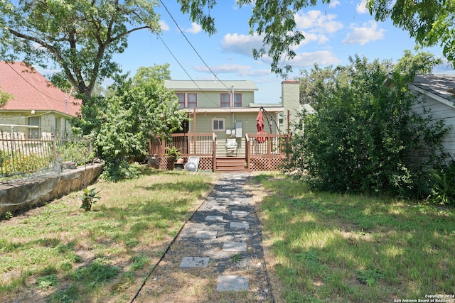 rear view of property featuring a wooden deck