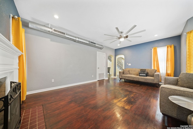 living room featuring ceiling fan and dark hardwood / wood-style floors