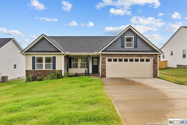 craftsman-style house with a front yard, a garage, and central air condition unit