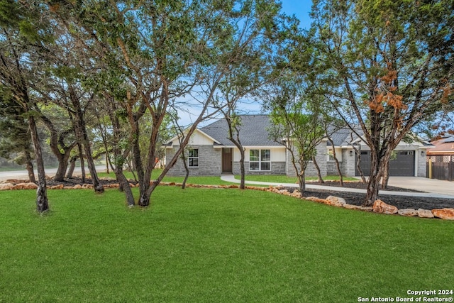 ranch-style house featuring a front yard and a garage