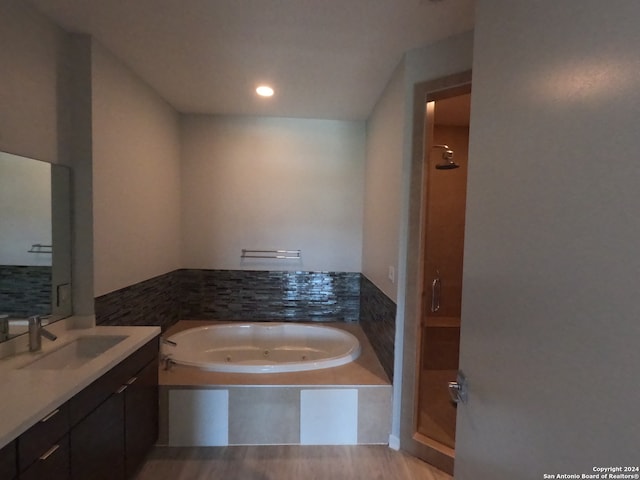 bathroom featuring independent shower and bath and large vanity