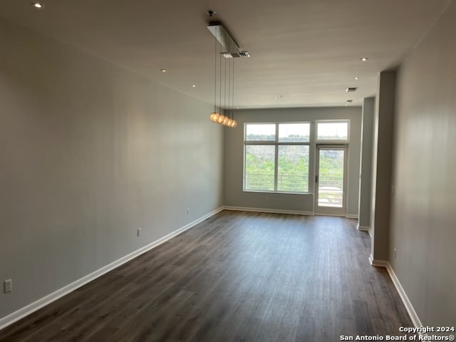 empty room featuring dark wood-type flooring