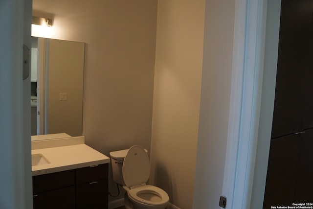 bathroom featuring toilet and large vanity