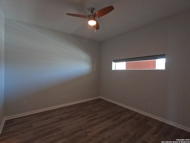 empty room with ceiling fan and dark hardwood / wood-style floors