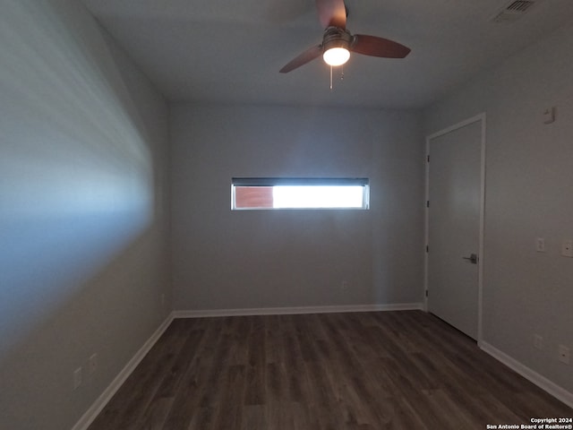 spare room featuring ceiling fan and dark hardwood / wood-style floors