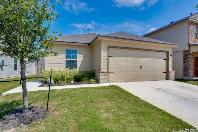 view of front of house featuring a garage and a front lawn