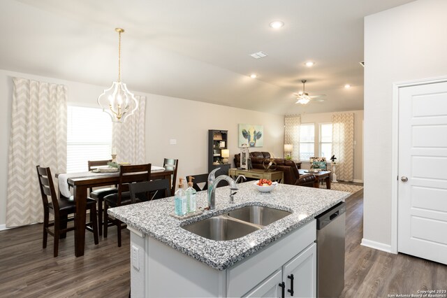 kitchen featuring sink, hanging light fixtures, dark wood-type flooring, and dishwasher