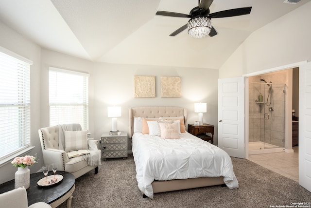 carpeted bedroom with lofted ceiling, ceiling fan, and ensuite bath