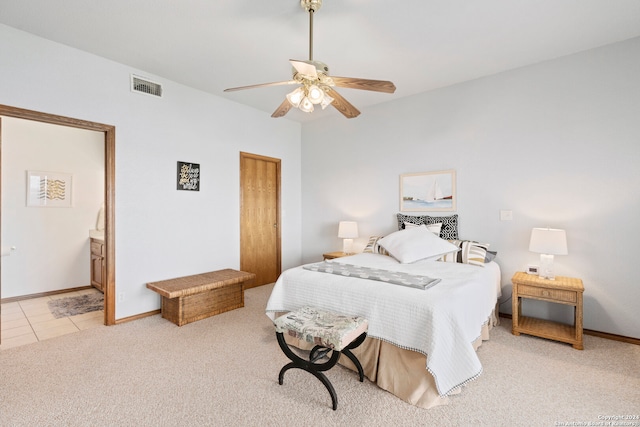 carpeted bedroom featuring ceiling fan and ensuite bathroom