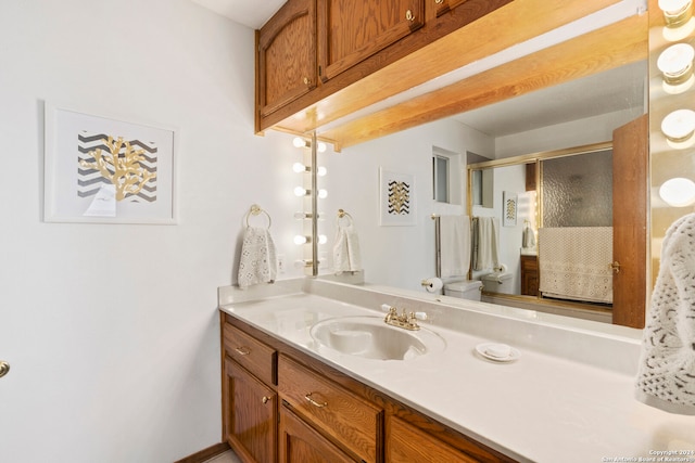 bathroom featuring oversized vanity and toilet