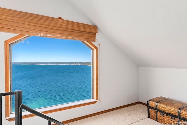 carpeted bedroom with a water view and lofted ceiling