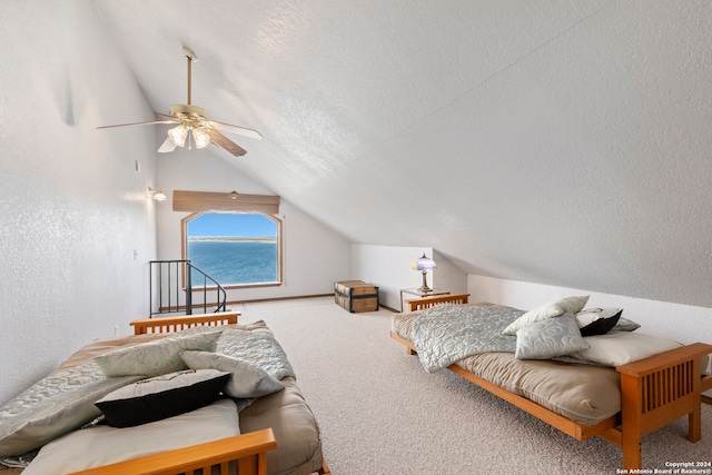 bedroom with a water view, carpet, ceiling fan, a textured ceiling, and lofted ceiling