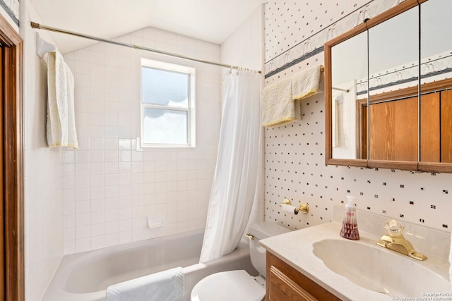 full bathroom featuring toilet, shower / bathtub combination with curtain, and vanity