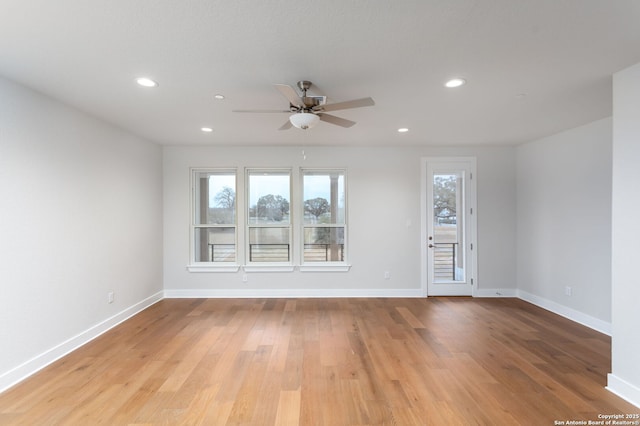 empty room with light hardwood / wood-style flooring and ceiling fan