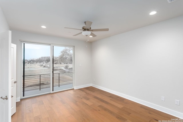 spare room featuring hardwood / wood-style floors and ceiling fan