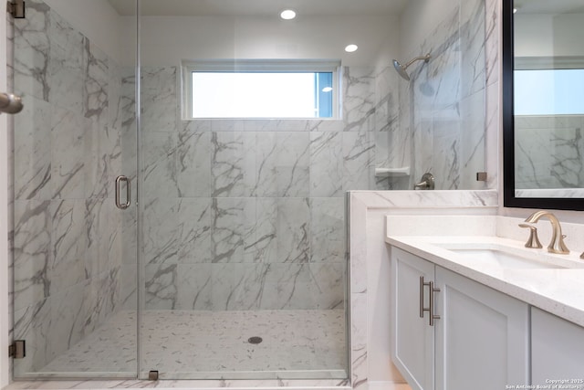 bathroom featuring vanity and an enclosed shower