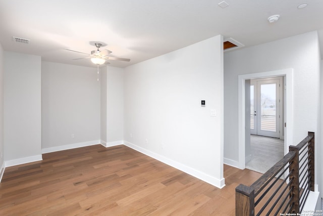 spare room featuring wood-type flooring and ceiling fan