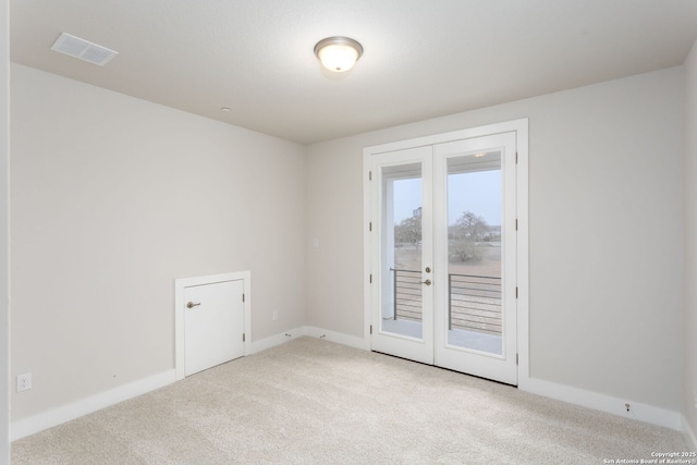 carpeted empty room with french doors