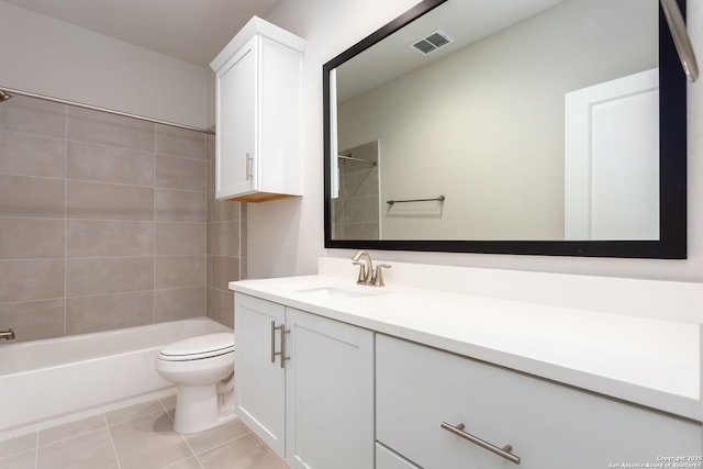 full bathroom featuring tile patterned flooring, vanity, tiled shower / bath combo, and toilet