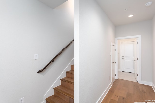 stairs with wood-type flooring