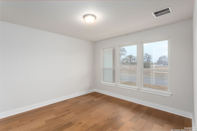 empty room with wood-type flooring