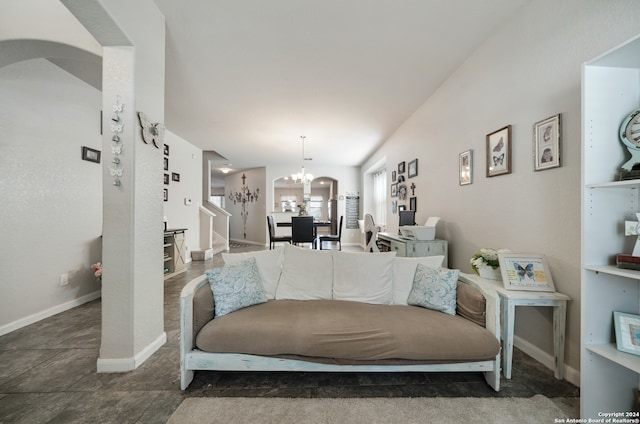 tiled living room featuring an inviting chandelier